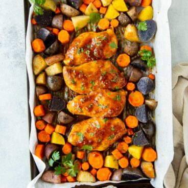 overhead image of apricot chicken sheet pan dinner on sheet pan