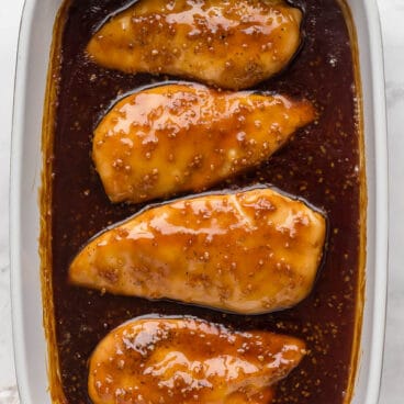 overhead image of honey garlic chicken breasts in baking dish