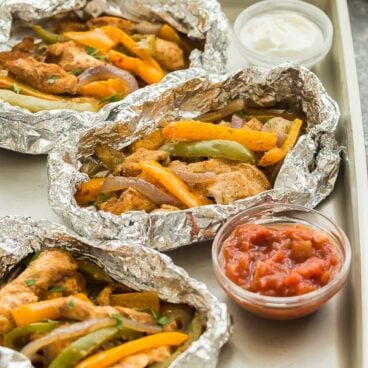 This Chicken Fajita Foil Packets is a family favorite! Easy to customize, loaded with chicken, peppers, red onions and a homemade fajita seasoning, and perfect for making ahead for an easy camping meal! #foilpack #foilpacket #chicken #grill #grilling #dinner #recipe
