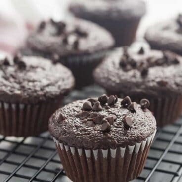 These Double Chocolate Muffins are so moist (thanks to buttermilk, canola oil and applesauce) and loaded with chocolate flavor! Make them with whole wheat flour for extra fiber! The perfect lunch box snack.