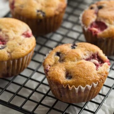 These Fruit Explosion Muffins are loaded with strawberries and blueberries (or any berries you want!) and have a strawberry jam surprise inside! They are made with whole wheat flour and sour cream makes them extra moist.