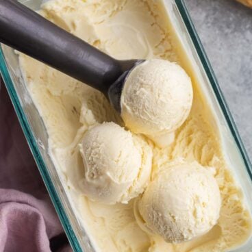 overhead image of pan of ice cream with three scoops sitting on top.