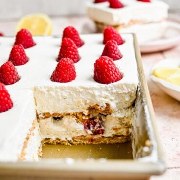 pan of lemon raspberry icebox cake with piece missing.