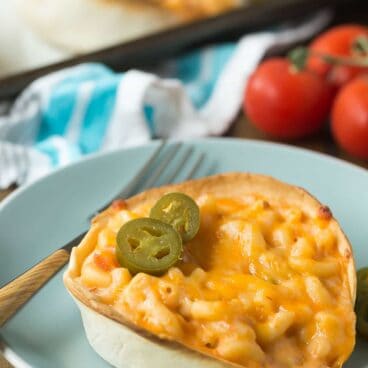 This Mexican Baked Mac and Cheese is packed with flavor from taco seasoning, salsa and baked in a tortilla bowl for a fun twist on taco night! The kids LOVE it!