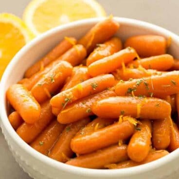 Carrots cook all day in a honey orange glaze and transport easily in the slow cooker or crockpot! These glazed carrots are the easiest Thanksgiving or Christmas side dish!