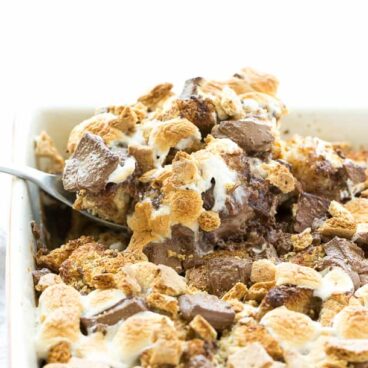 S'mores Overnight French Toast Casserole: An easy, overnight french toast casserole is topped with marshmallows, chocolate chunks and graham crackers and baked until irresistibly gooey -- the perfect breakfast, brunch or brinner to take you from summer right through back to school! Only 8 ingredients! www.thereciperebel.com