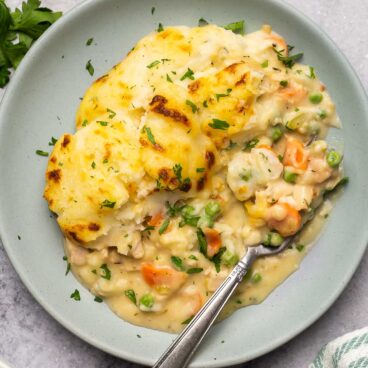 overhead image of leftover turkey shepherd's pie on grey plate with fork.